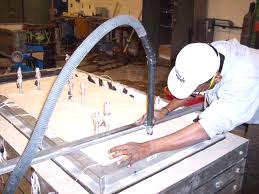 a leveller (worker) levelling a surface using a leveller (device)