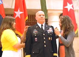 a major general having his flags pinned to his uniform