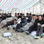 migrants at a temporary shelter