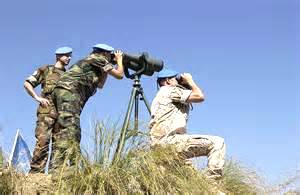 UN military observers observing the military activities in an area
