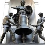 (a sculpture of bell ringers)