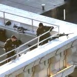 snipers on a roof-top, waiting for the criminals to show up on the street below