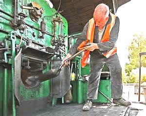 a stoker feeding the boiler of a steam locomotive
